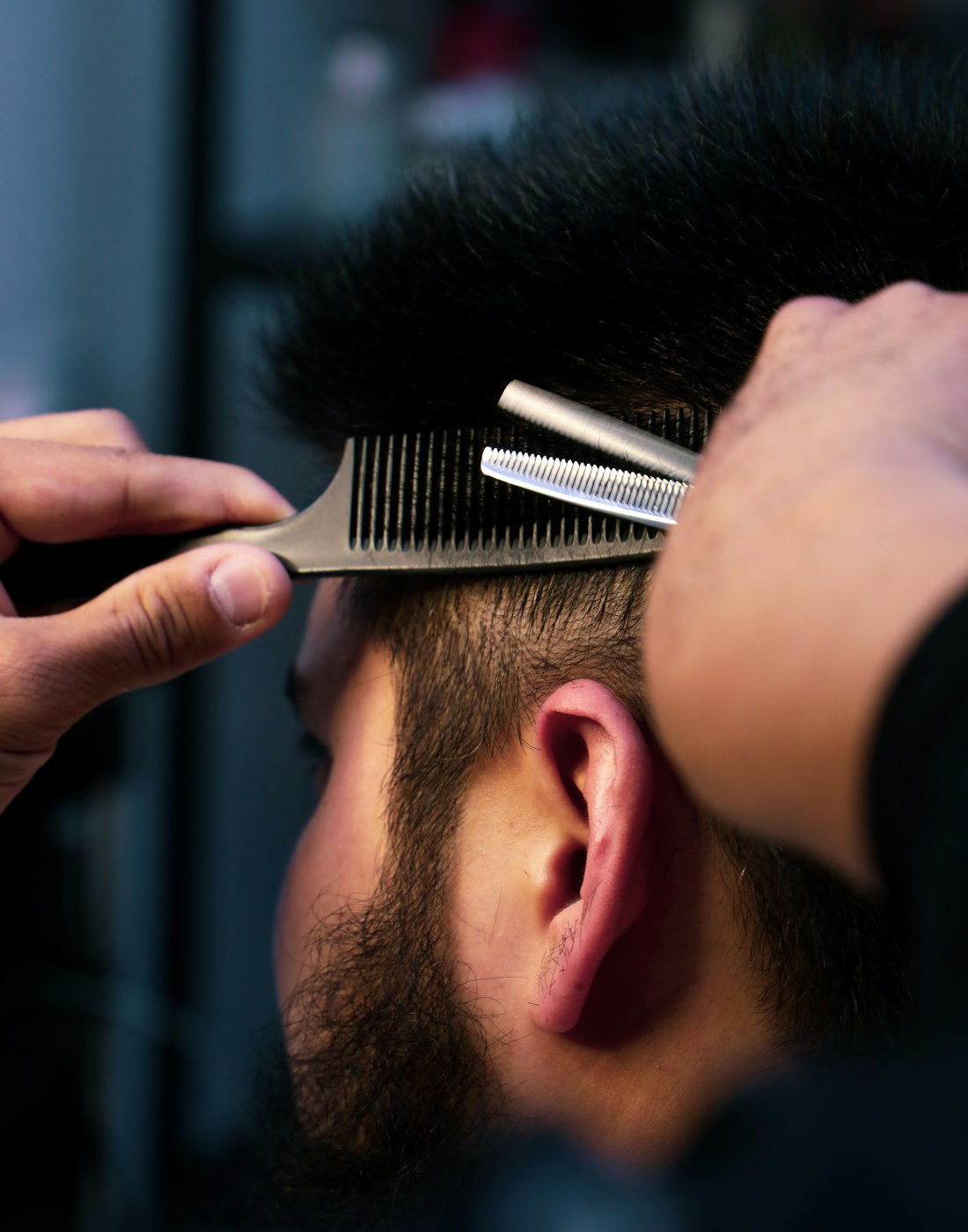 A beard being shaped with scissors