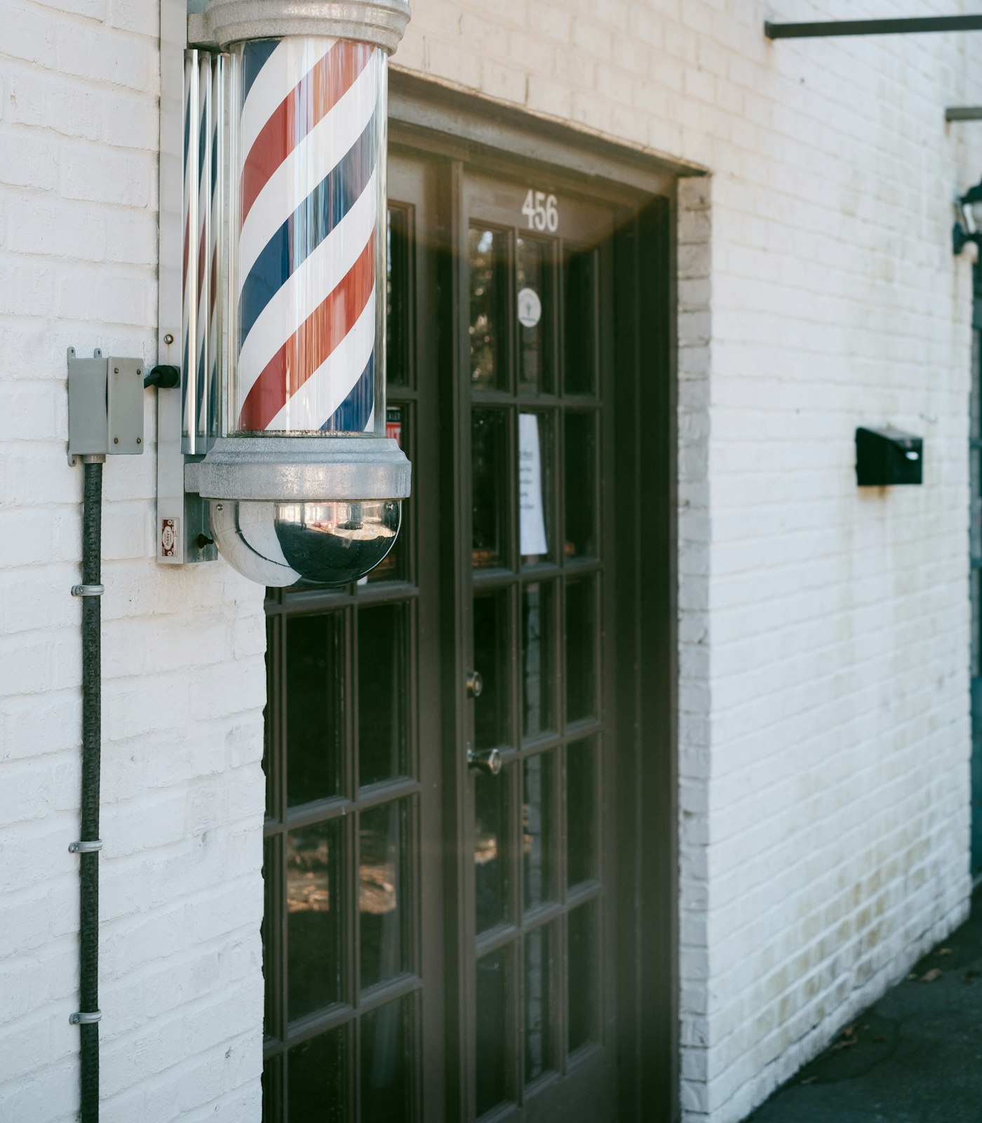 The shopfront on Bridge Street, barber pole by the door