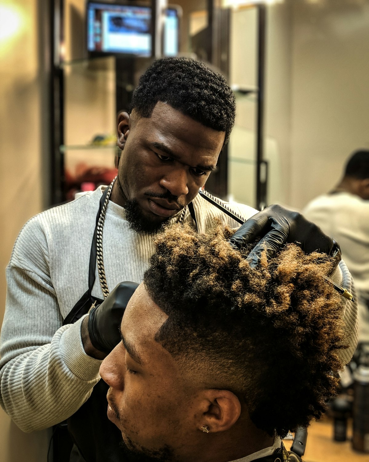 A scissor cut in progress at the first chair
